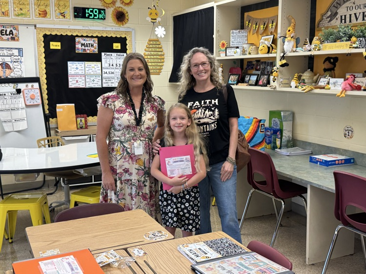 Mrs. Balderson smiles with a student and family during a back-to-school meet-and-greet in her classroom. 