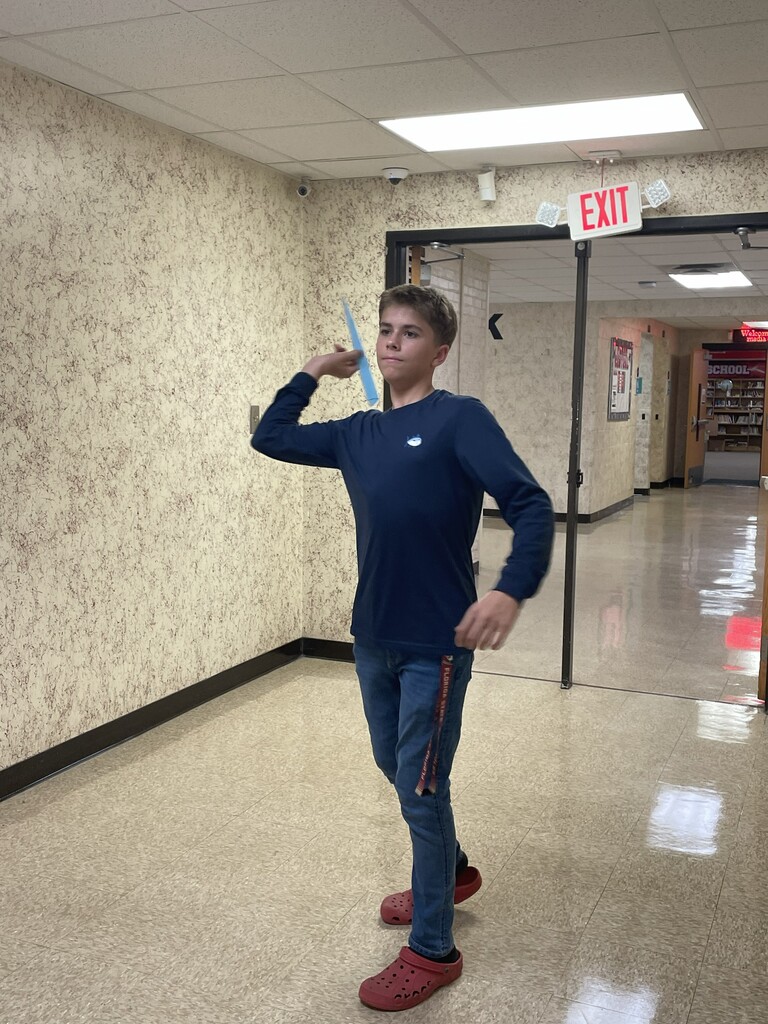 Students throwing paper airplane