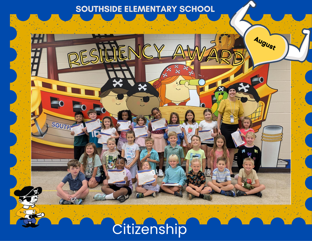 Group photo of children and a few adults indoors in front of a colorful pirate ship mural with a large skull-and-crossbones design, palm tree, and “South…” sign on the wall.