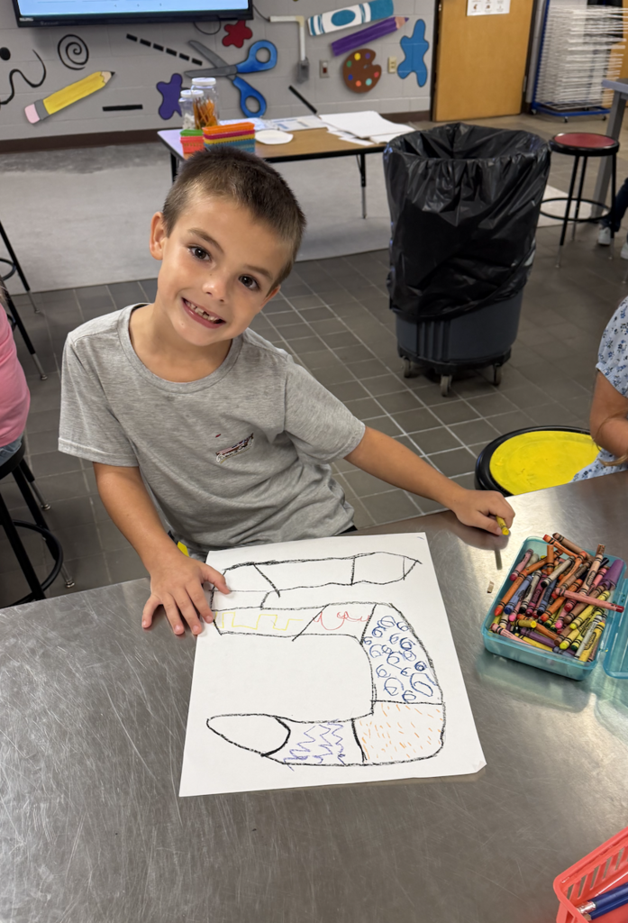 student drawing a variety of zigzag and curved lines in the form of a snake