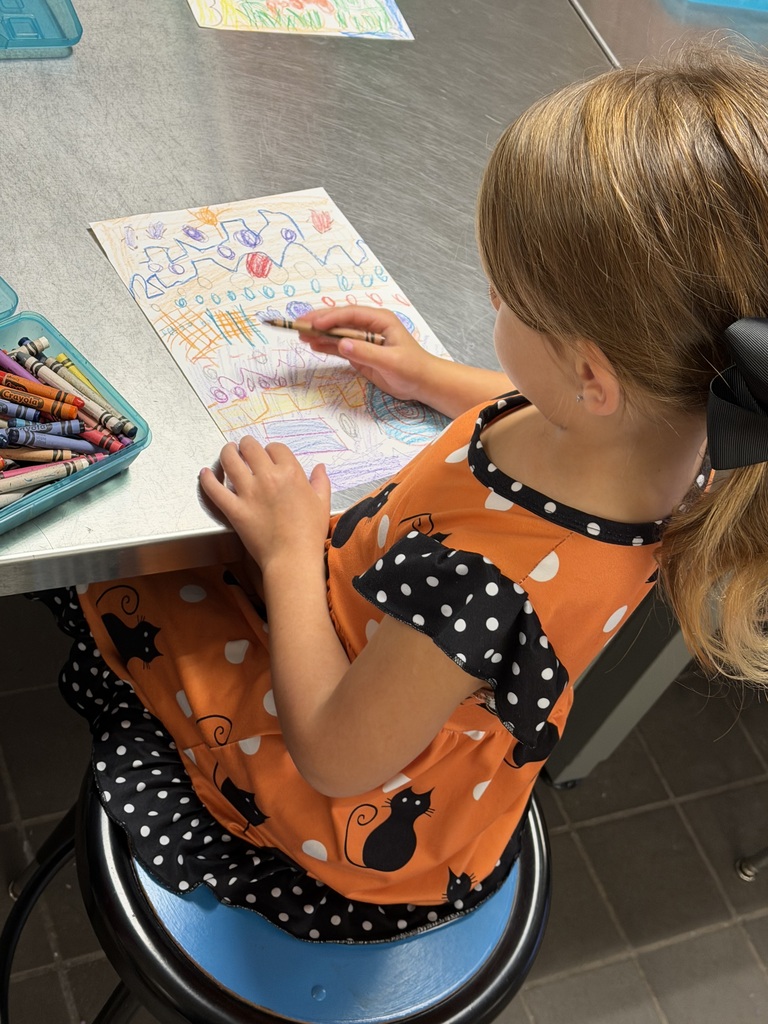 student drawing a variety of zigzag and curved lines