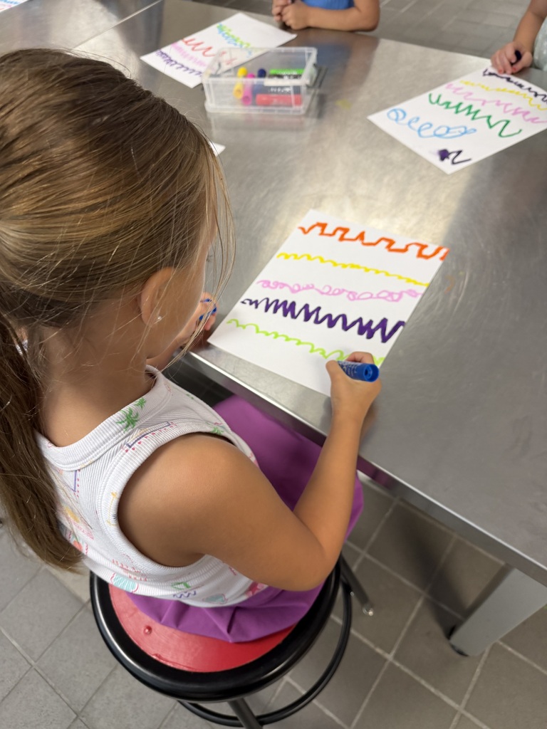 student drawing a variety of zigzag and curved lines