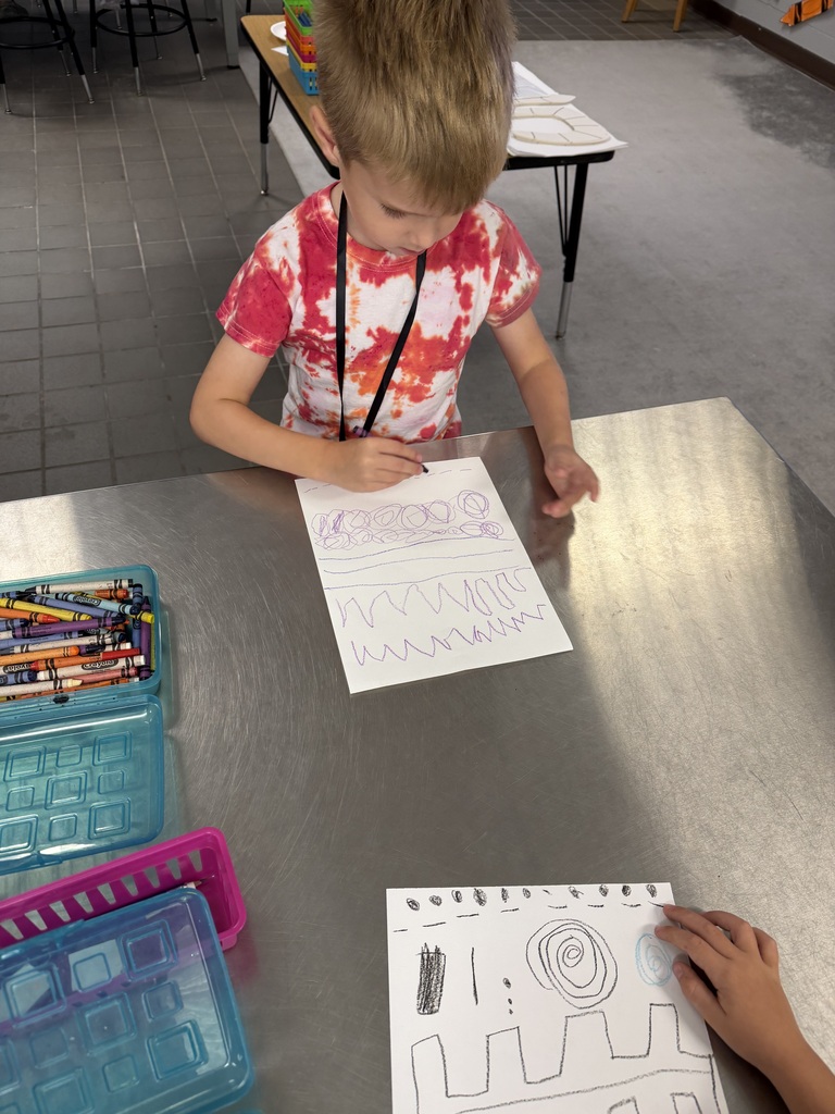 student drawing a variety of zigzag and curved lines