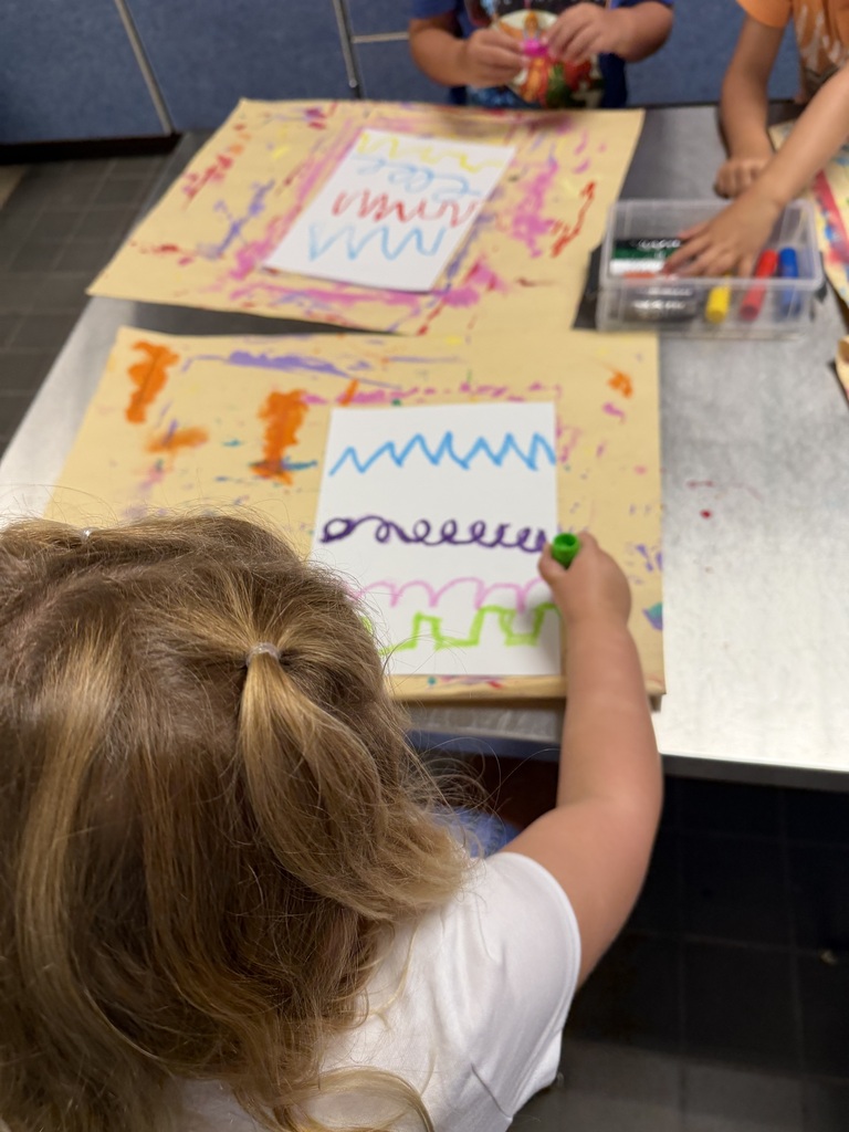 student drawing a variety of zigzag and curved lines
