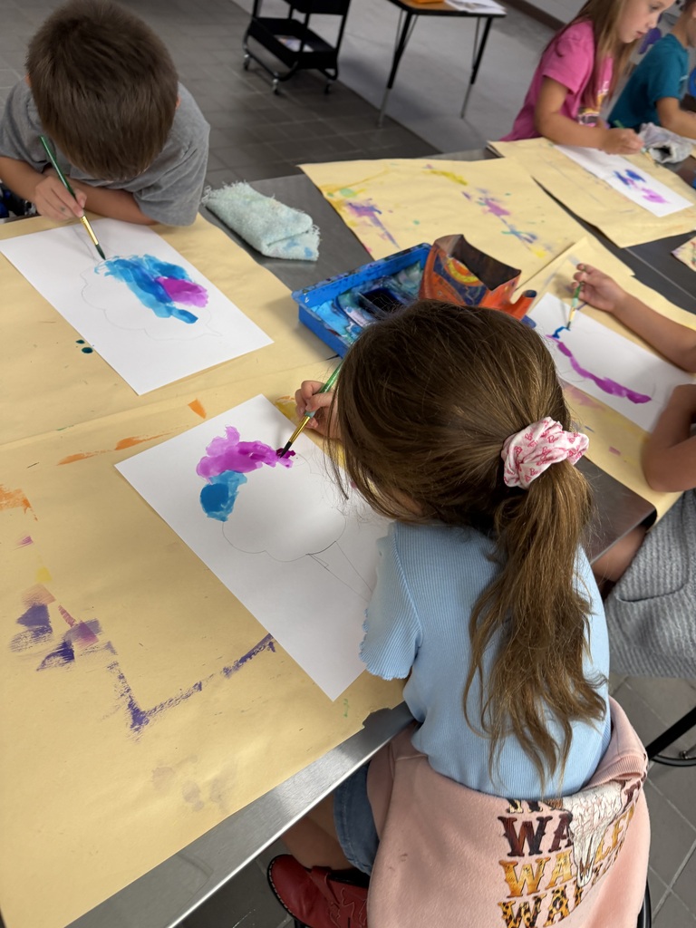 student painting in art class