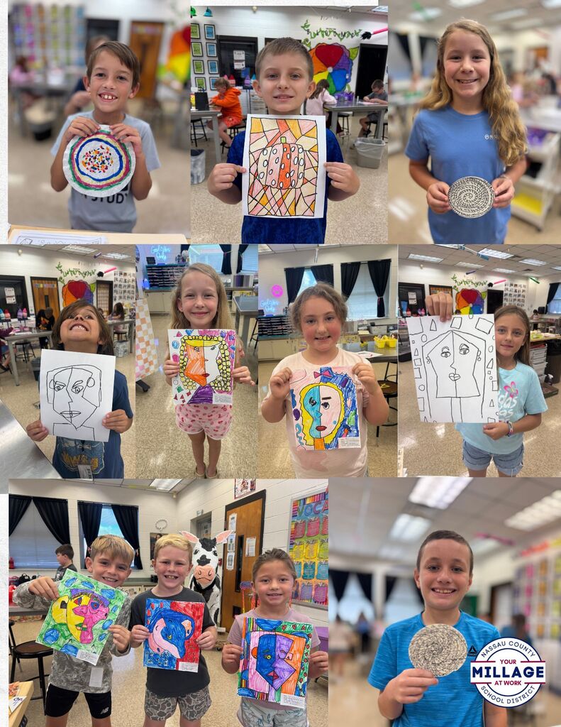 Different students holding up self created art