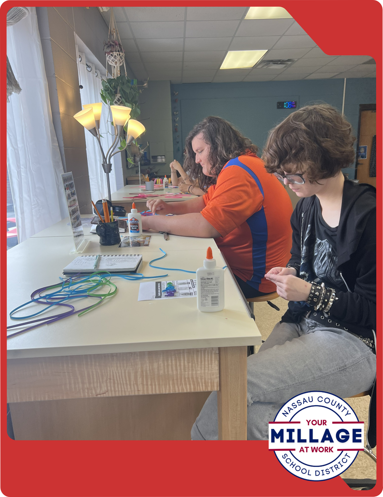 Students are learning to roll, shape, and arrange thin strips of paper into intricate designs, turning simple materials into beautiful works of art.