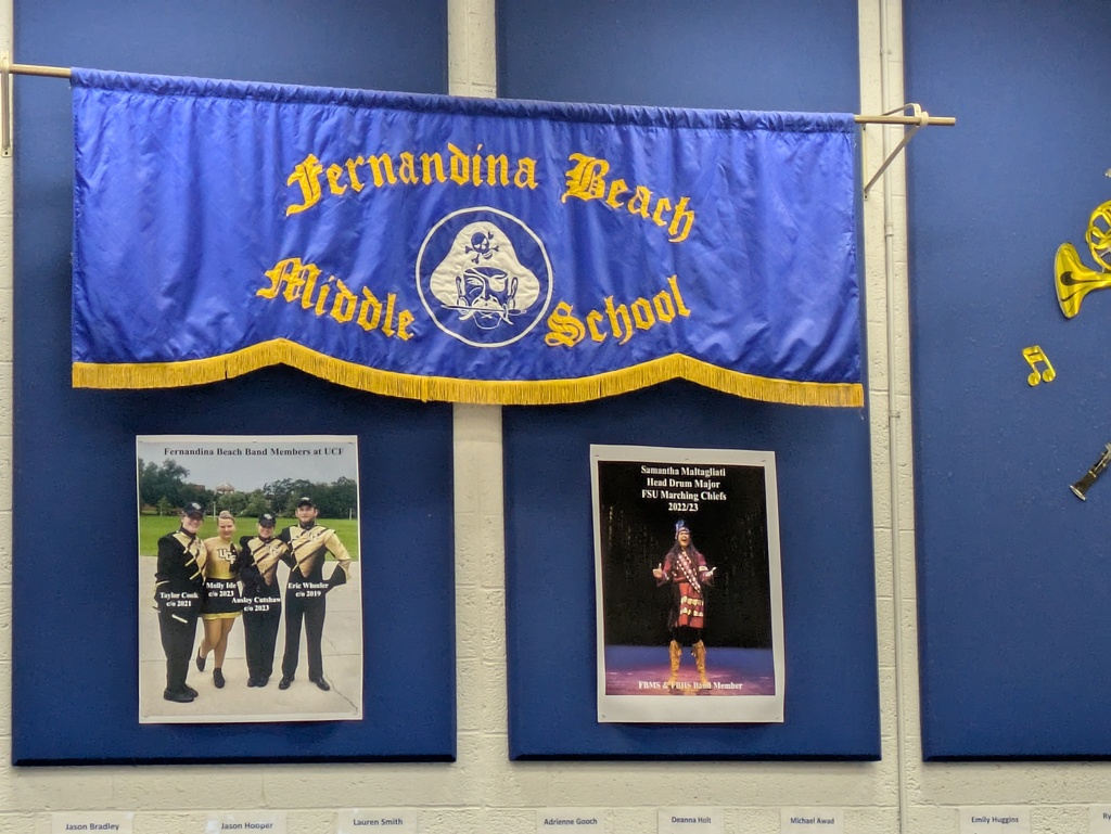 Fernandina Beach Middle School band banner displayed on a classroom wall above student achievement posters.