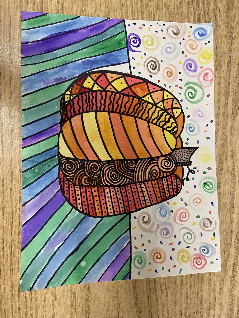 Colorful student artwork featuring a patterned acorn with bright stripes, swirls, and geometric designs.