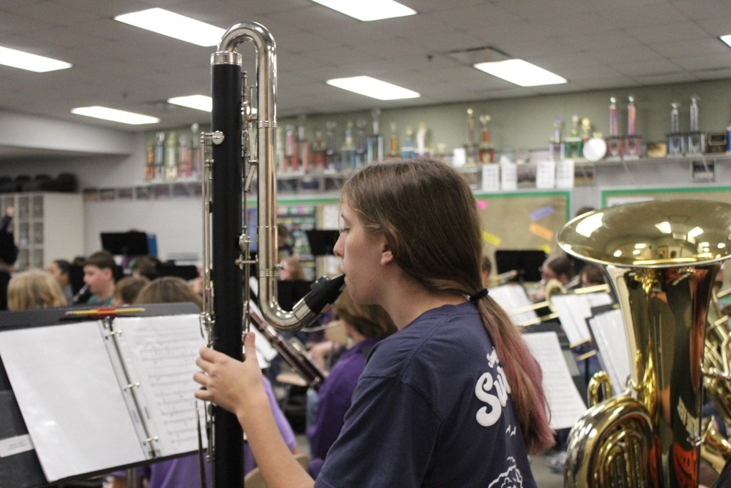 student playing instrument in band class
