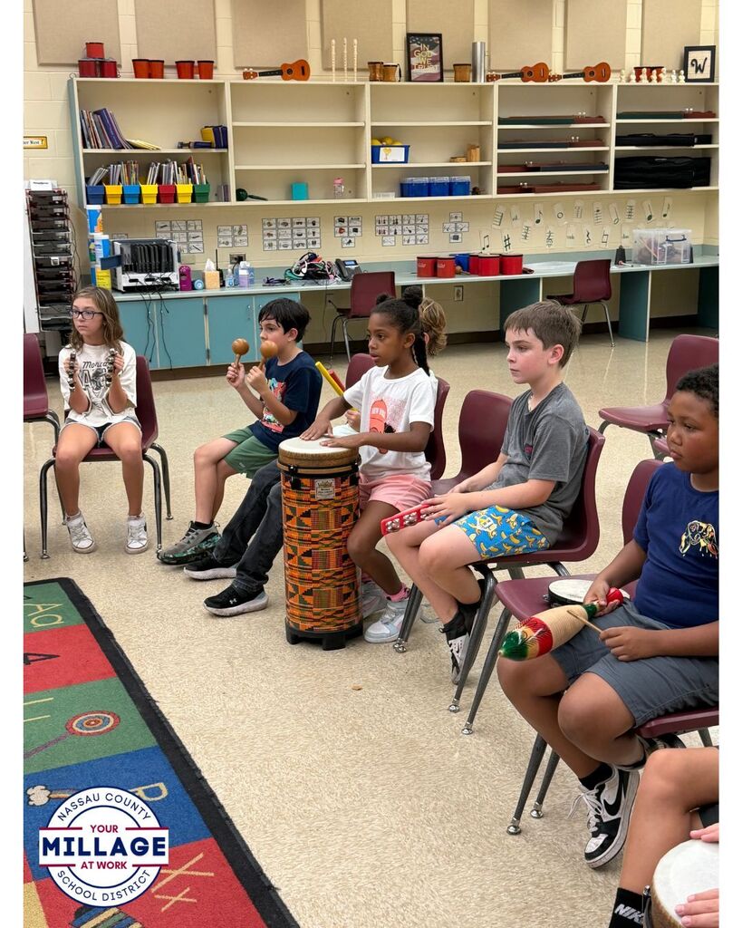 Students in the Music room playing musical instruments 