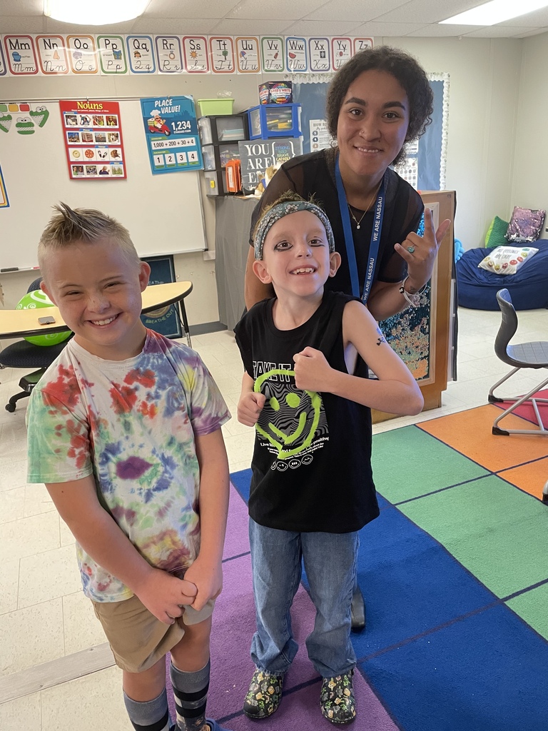 Students and teacher dressed up as a rock and roll singer/star.
