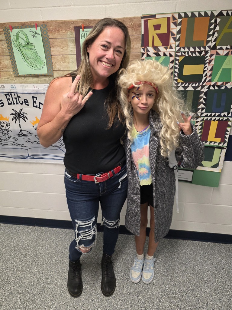 Student and teacher dressed up as a rock and roll singer/star.