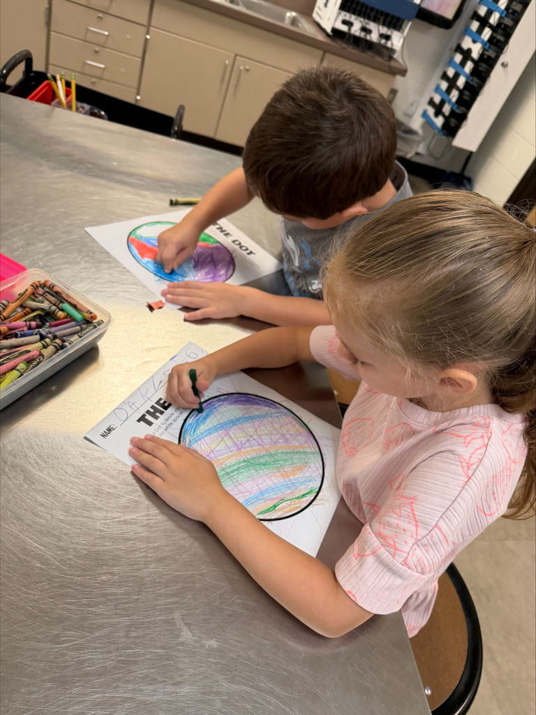 Kindergarten Trailblazers celebrate Dot Day by using crayons and colorful art supplies to creatively design and decorate their own dots, showcasing their unique ideas and artistic expression.