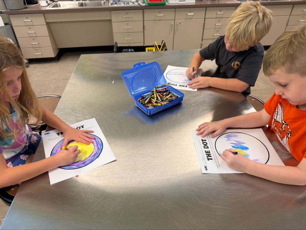 Kindergarten Trailblazers celebrate Dot Day by using crayons and colorful art supplies to creatively design and decorate their own dots, showcasing their unique ideas and artistic expression.