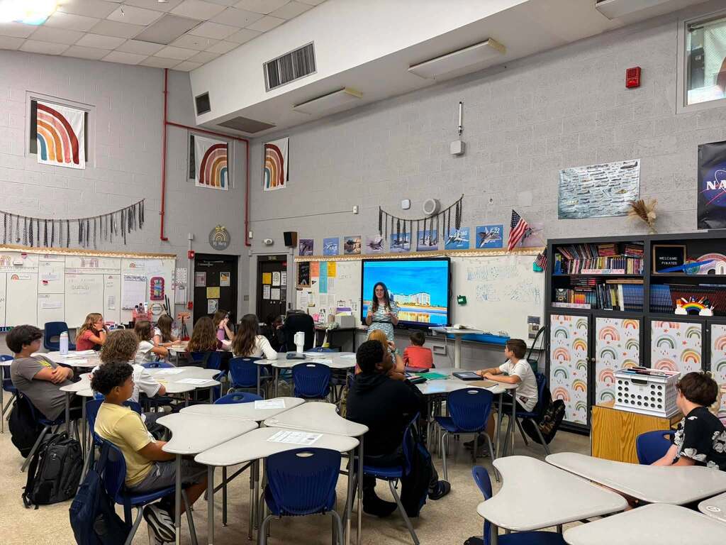 A hospitality industry professional speaks with Fernandina Beach Middle School students during a classroom career exploration presentation about hospitality and tourism.