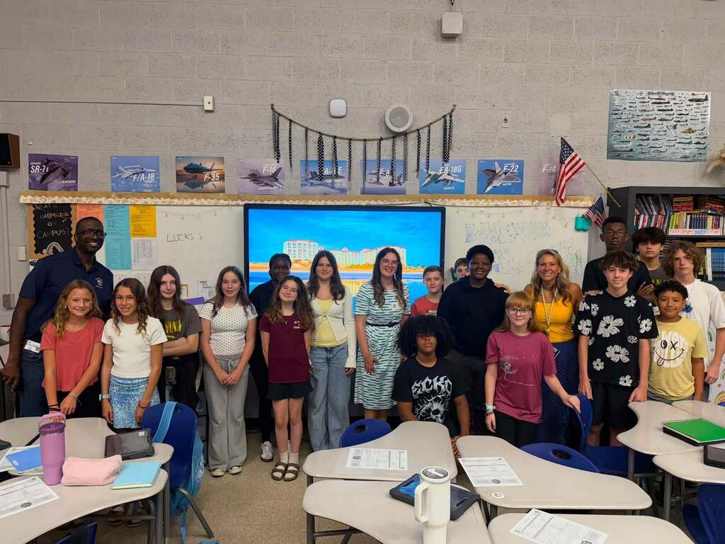 Fernandina Beach Middle School students and hospitality industry professionals gather for a group photo after a Career and Technical Education presentation on hospitality and tourism careers.
