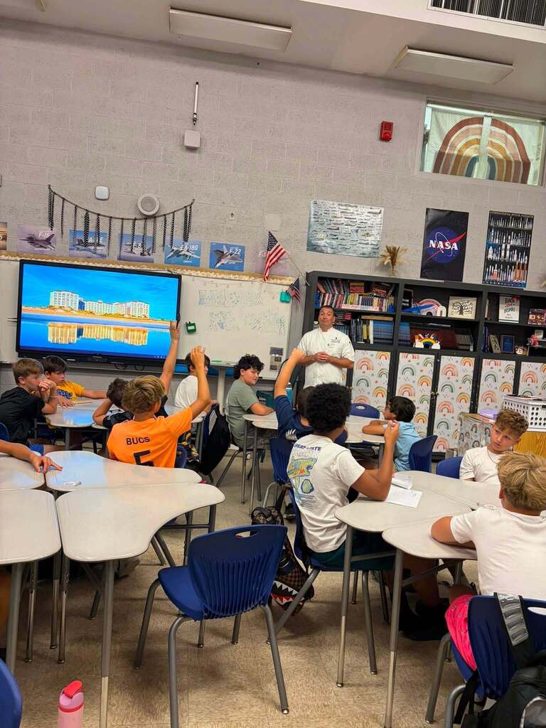 A hospitality industry professional speaks with Fernandina Beach Middle School students during a classroom career exploration presentation about hospitality and tourism.
