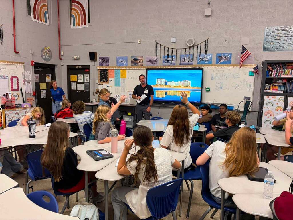 A hospitality industry professional speaks with Fernandina Beach Middle School students during a classroom career exploration presentation about hospitality and tourism.