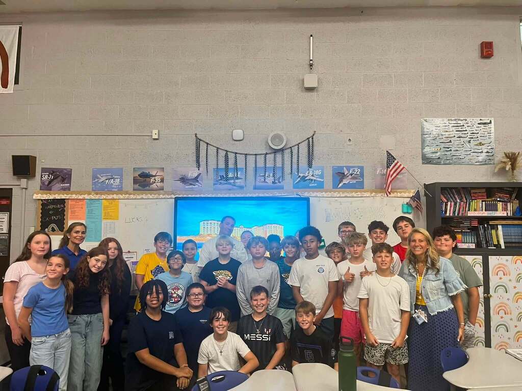 Fernandina Beach Middle School students and hospitality industry professionals gather for a group photo after a Career and Technical Education presentation on hospitality and tourism careers.
