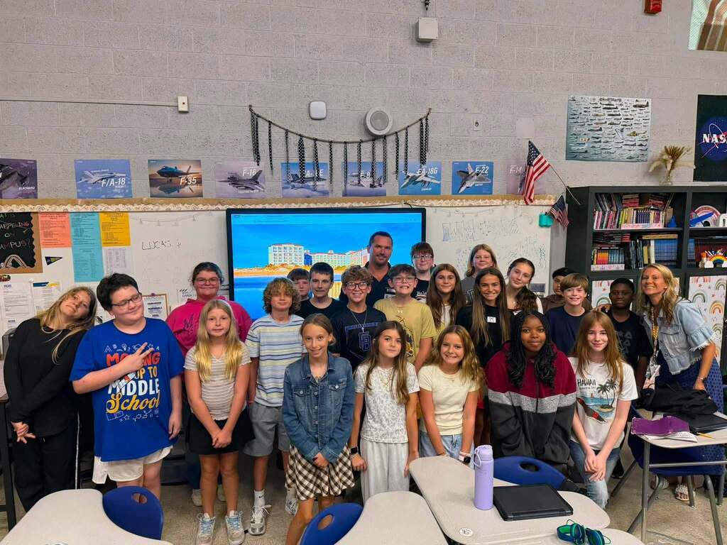 Fernandina Beach Middle School students and hospitality industry professionals gather for a group photo after a Career and Technical Education presentation on hospitality and tourism careers.