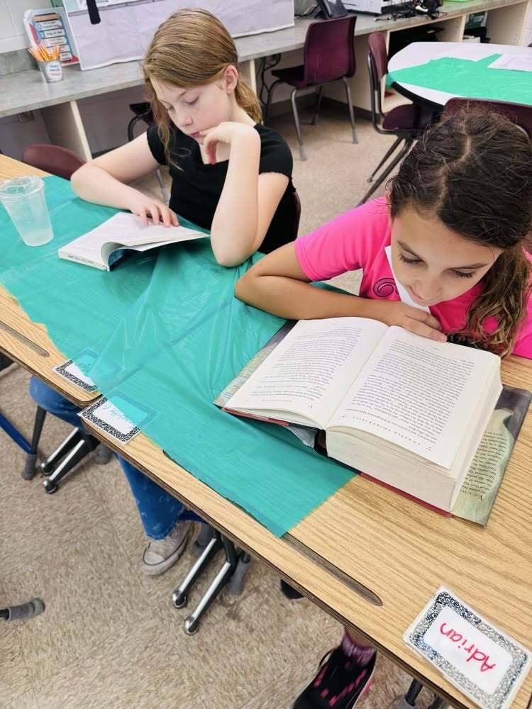 Two Callahan Intermediate School students read books at a classroom table during the STARBOOKS literacy activity.