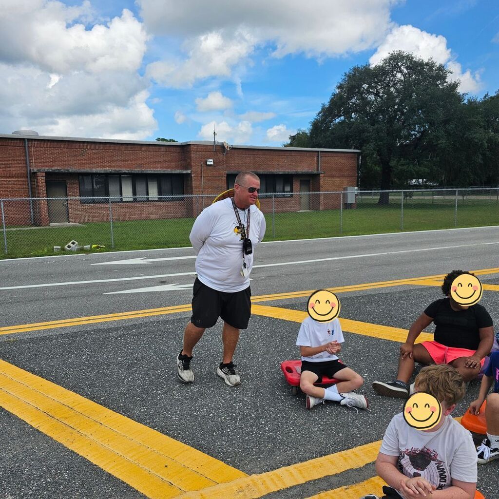 Coach Tate with students out at PE.
