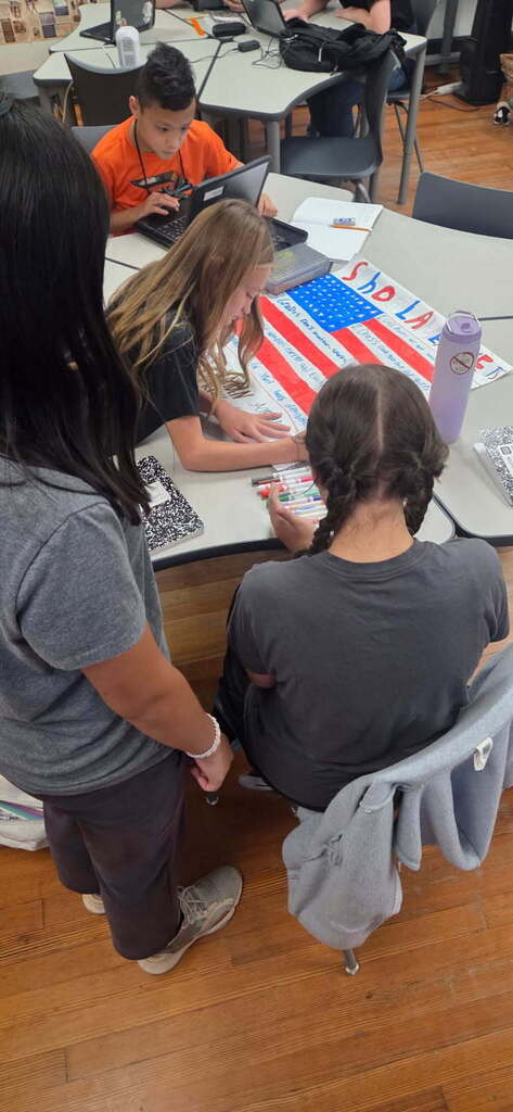 Students creating posters in Mr. West class.