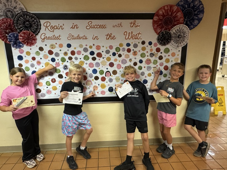 Students who received Warrior praise pointing towards their self-portrait dots
