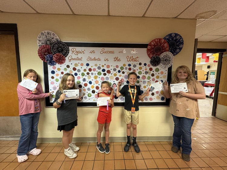Students who received Warrior praise pointing towards their self-portrait dots