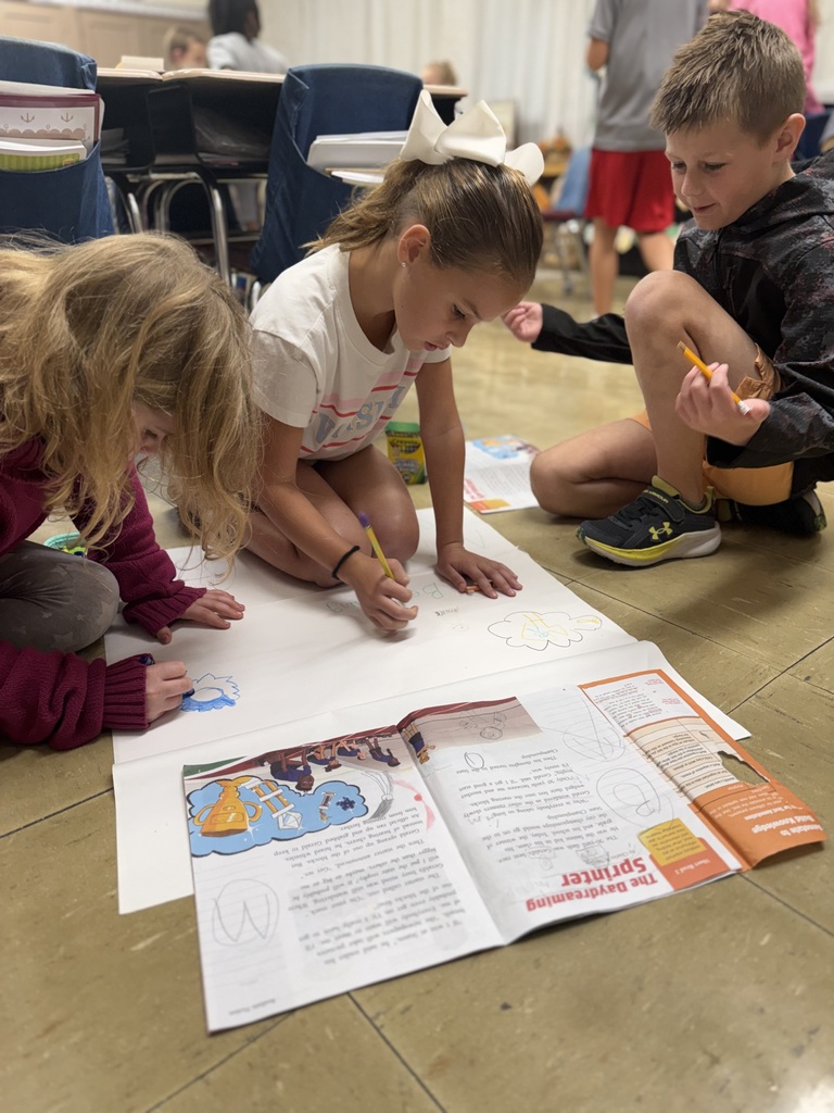 student writing on paper as a group