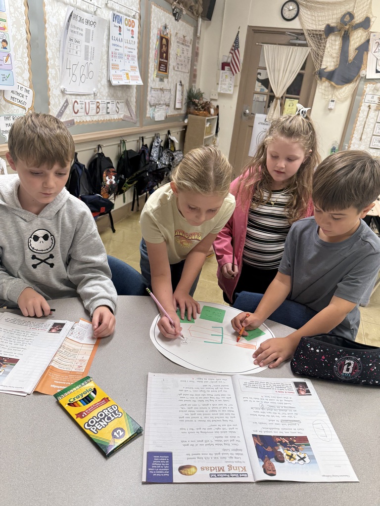 students writing on paper as a group