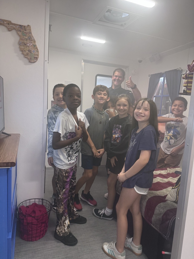 Students inside a smoky appearing fire simulator.