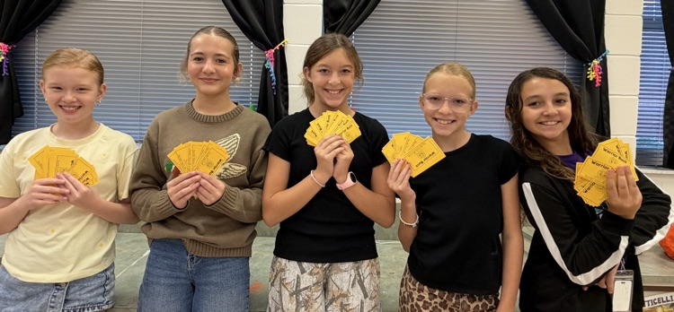 A group of girls showing off their Warrior Bucks.