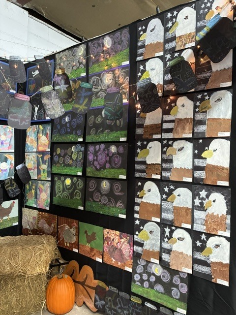 Student art of different medias displayed at the NEFL Fair. Eagles, chickens, and owls are depicted.