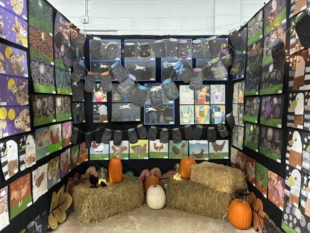 Student art of different medias displayed at the NEFL Fair. Eagles, chickens, and owls are depicted.