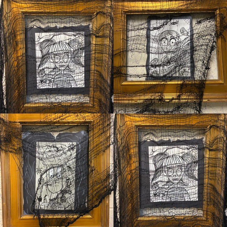 student spooky portraits in gold frame which also has black thin netting over it to give it a spooky feel