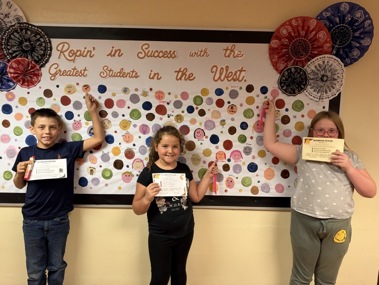 A group of CIS students showing off their Warrior Praise and personalized dot.
