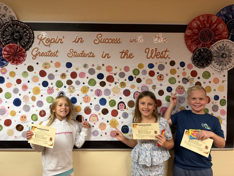 A group of CIS students showing off their Warrior Praise and personalized dot.