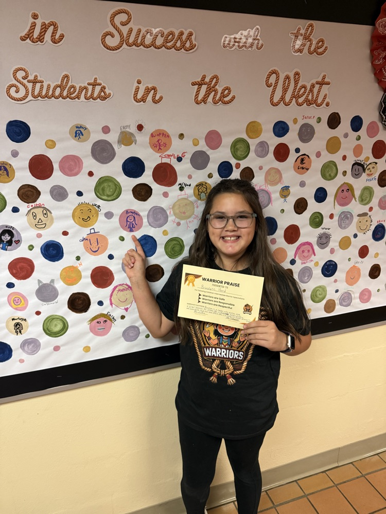 A students showing off her Warrior Praise and personalized dot.