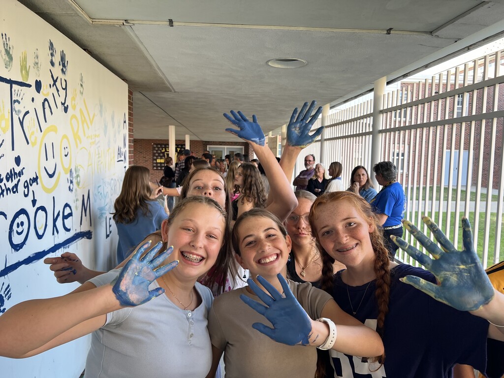 students paint mural at middle school