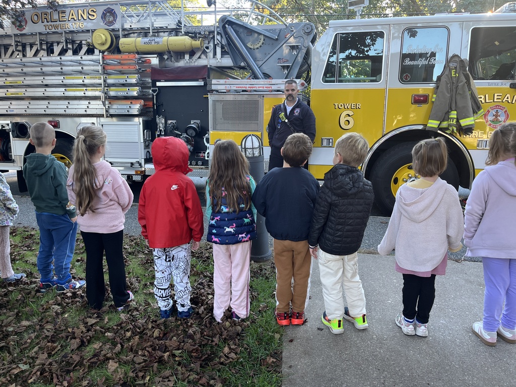 students stand in front of fire truck