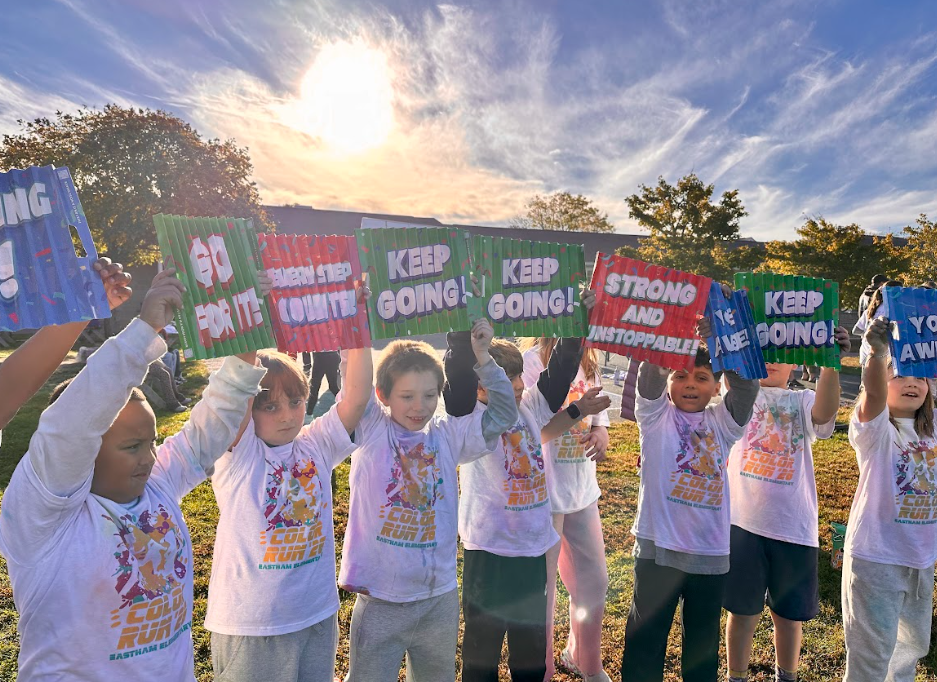 students hold signs at color run