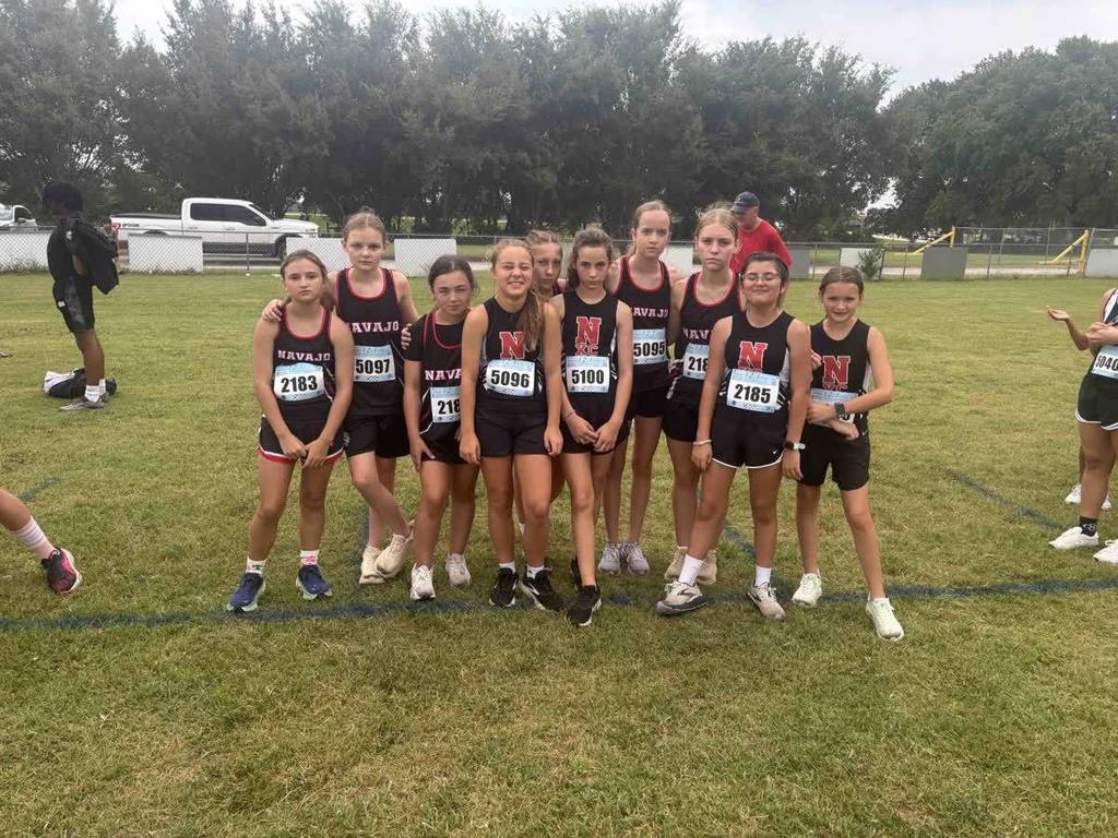 group picture of cross country middle school girls making a serious face. 