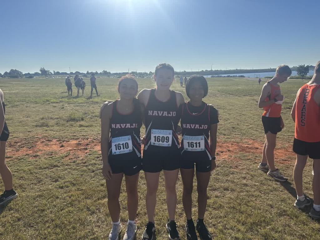 Navajo cross country students crossing the finish line.