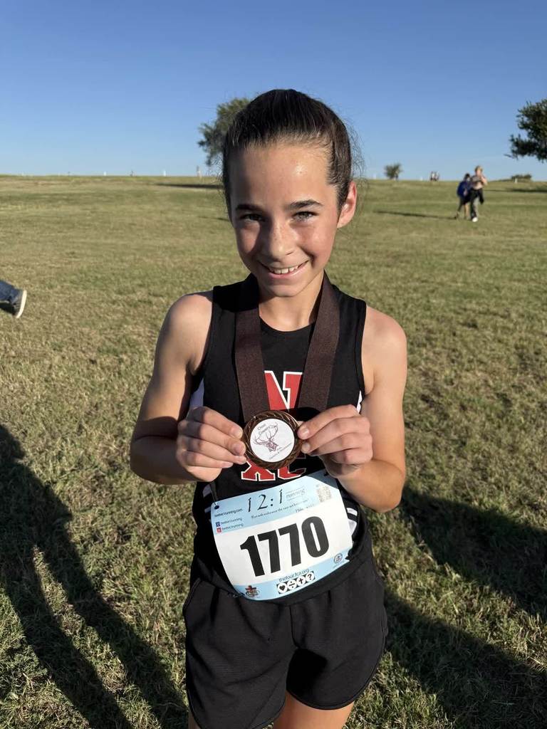 Navajo cross country students crossing the finish line.