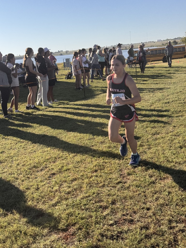 Navajo cross country students crossing the finish line.