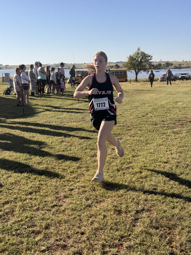 Navajo cross country students crossing the finish line.