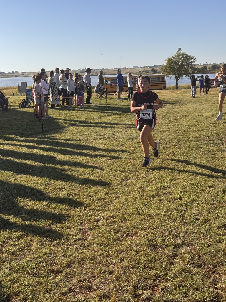 Navajo cross country students crossing the finish line.