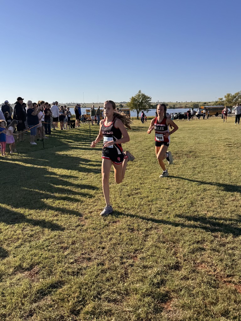 Navajo cross country students crossing the finish line.